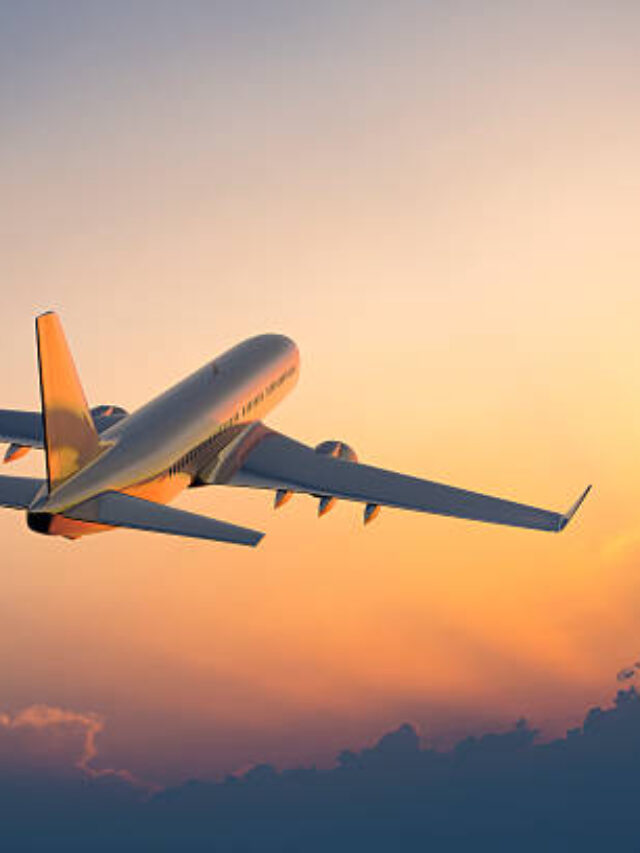 Passanger airplane flying above clouds in evening.